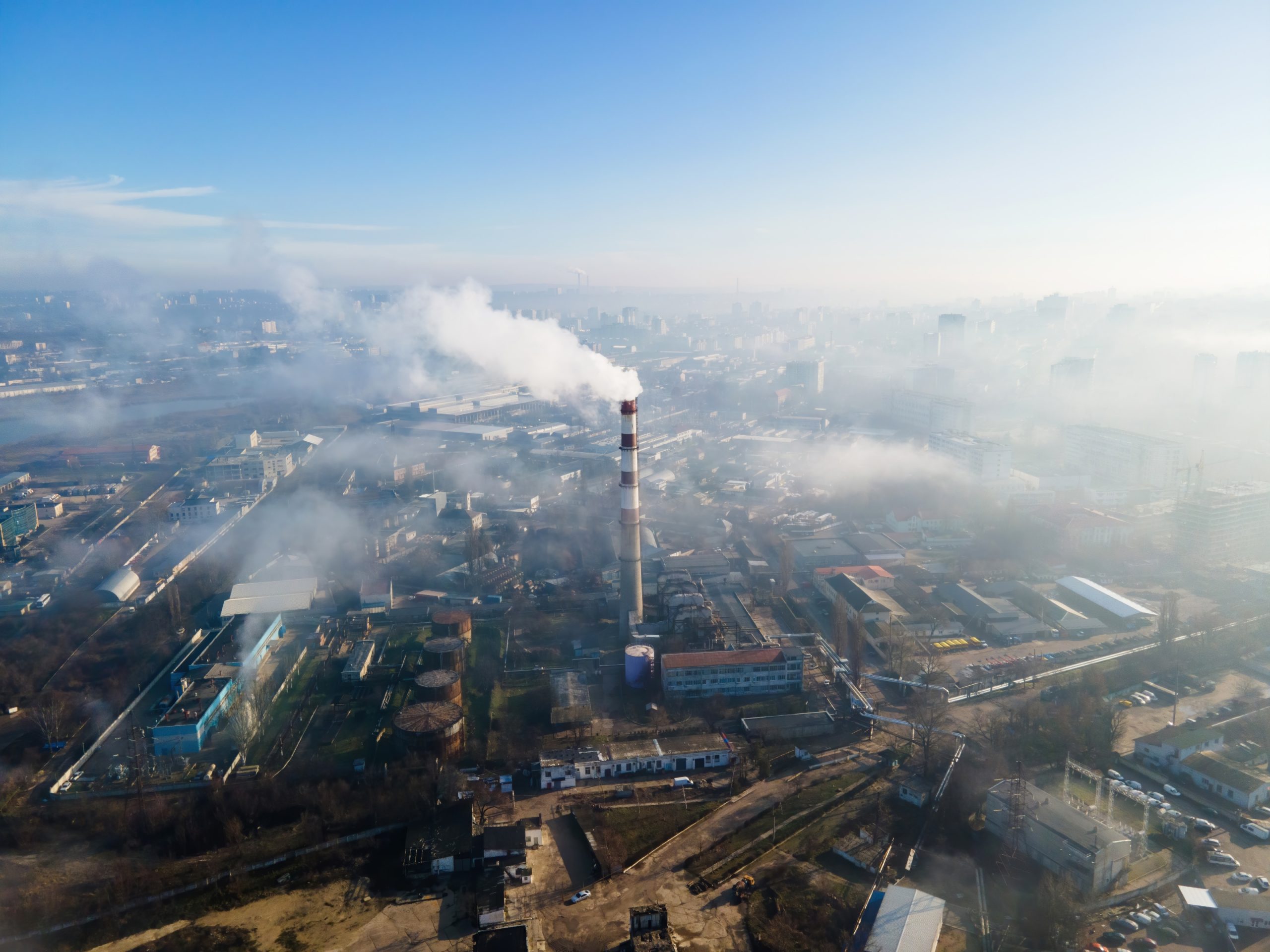 aerial-drone-view-chisinau-thermal-station-with-smoke-coming-out-tube-buildings-roads-fog-air-moldova-1-scaled.jpg
